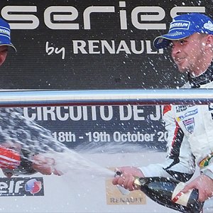 IWI Watches Ambassador Will Stevens celebrating on the podium in Jerez with Champagne and spraying Oliver Rowland of Racing Steps Foundation